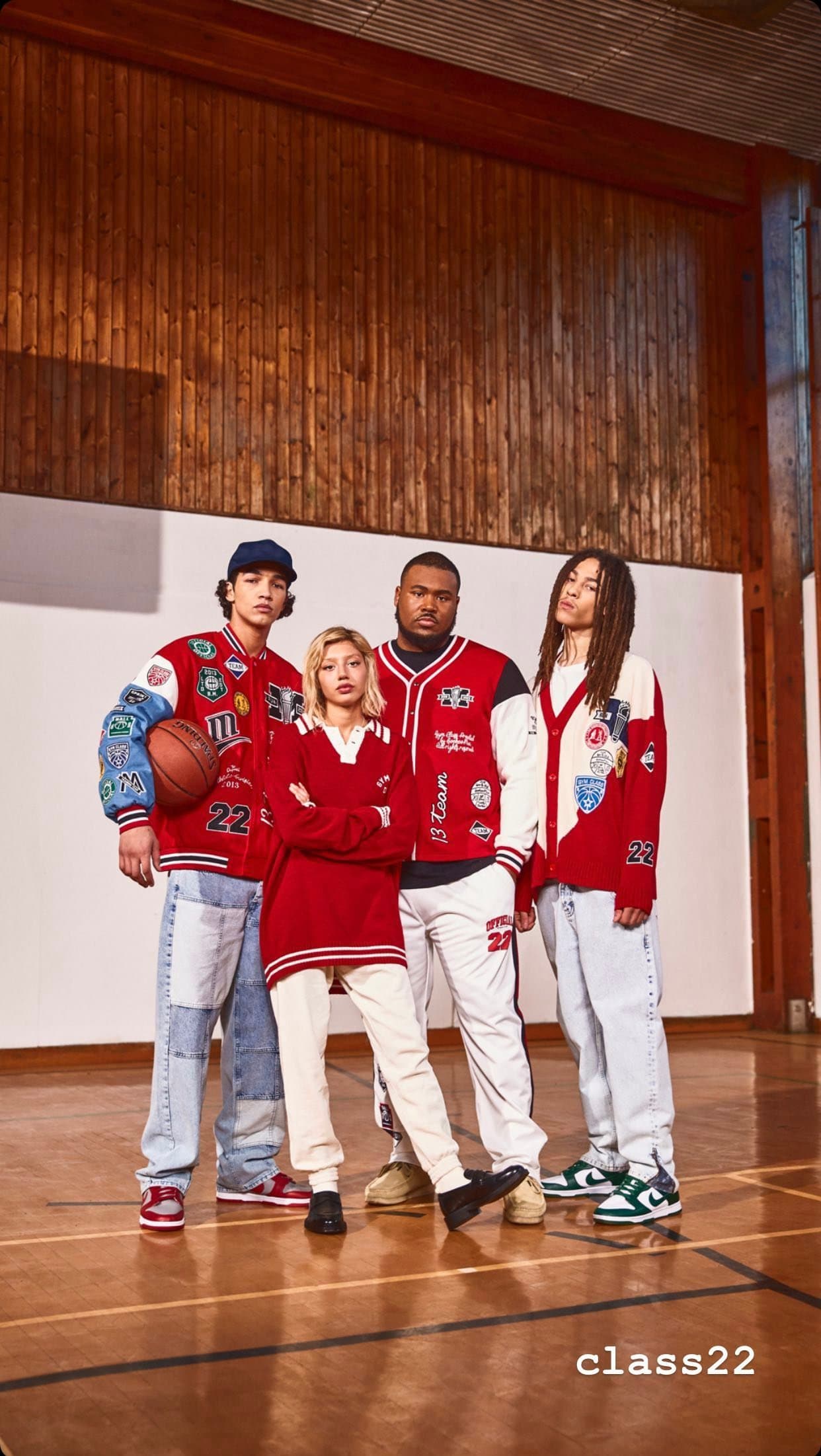 Gym Class(ic) campaign: group in varsity jackets on a sports hall court